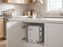 Load image into Gallery viewer, Aero·RO drinking-water faucet filling a glass with the tankless RO unit installed under the sink
